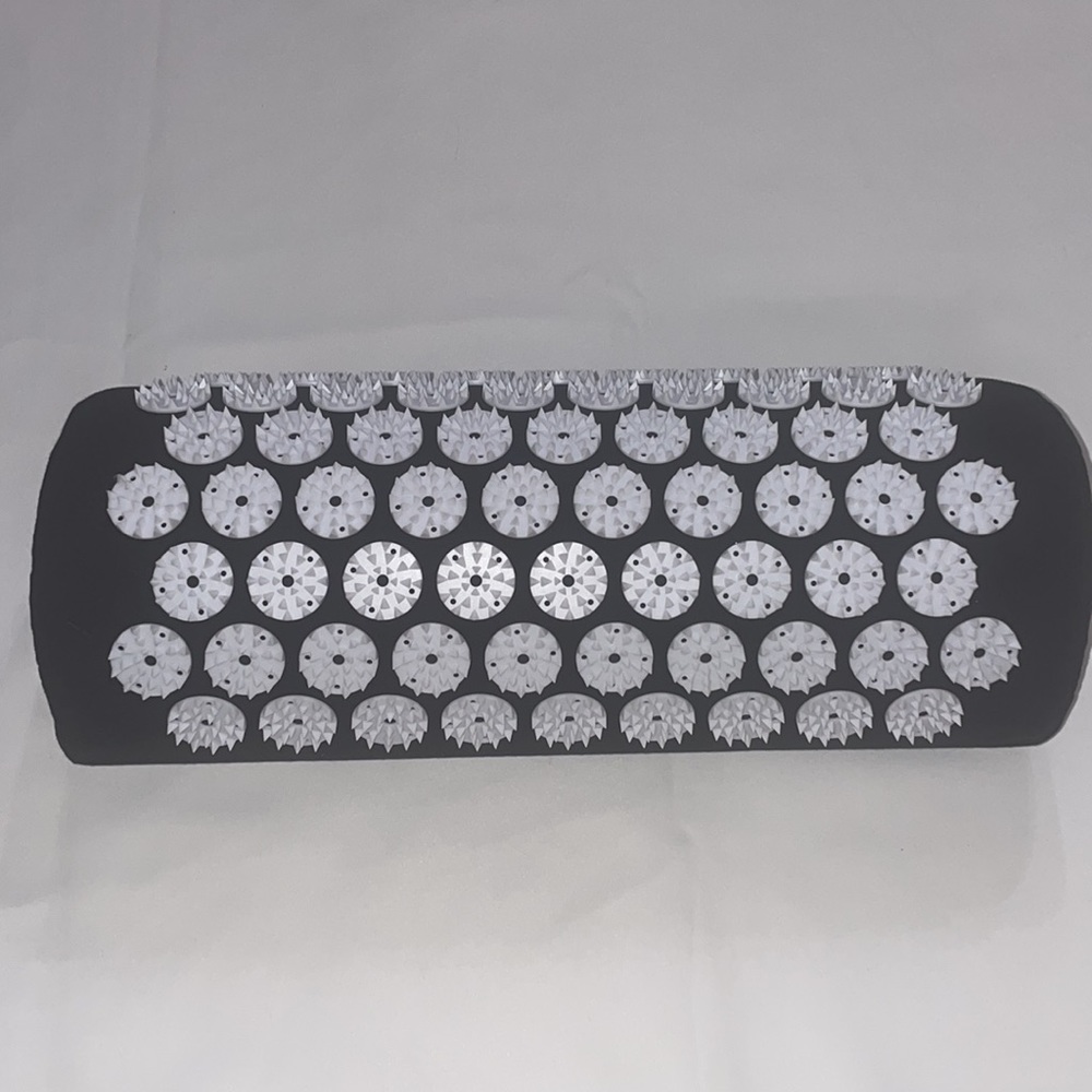 pillow covered in acupressure points for neck support and more holistic pain rel